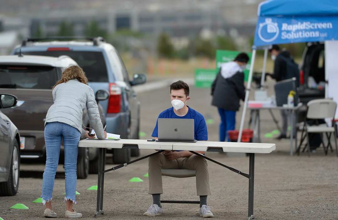 (Francisco Kjolseth  |  The Salt Lake Tribune) Nathan Hicken with Rapid Screen Solutions does quick data entry as people line up in their cars for COVID-19 antibody testing at the Galena Hills Park in Draper on Wednesday, May 20, 2020.