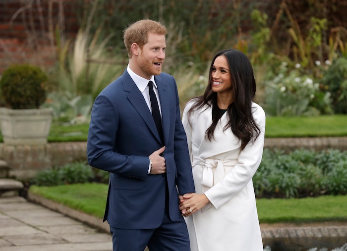 Britain's Prince Harry and his fiancee Meghan Markle pose for photographers during a photocall in the grounds of Kensington Palace in London, Monday Nov. 27, 2017. Britain's royal palace says Prince Harry and actress Meghan Markle are engaged and will marry in the spring of 2018. (AP Photo/Matt Dunham)