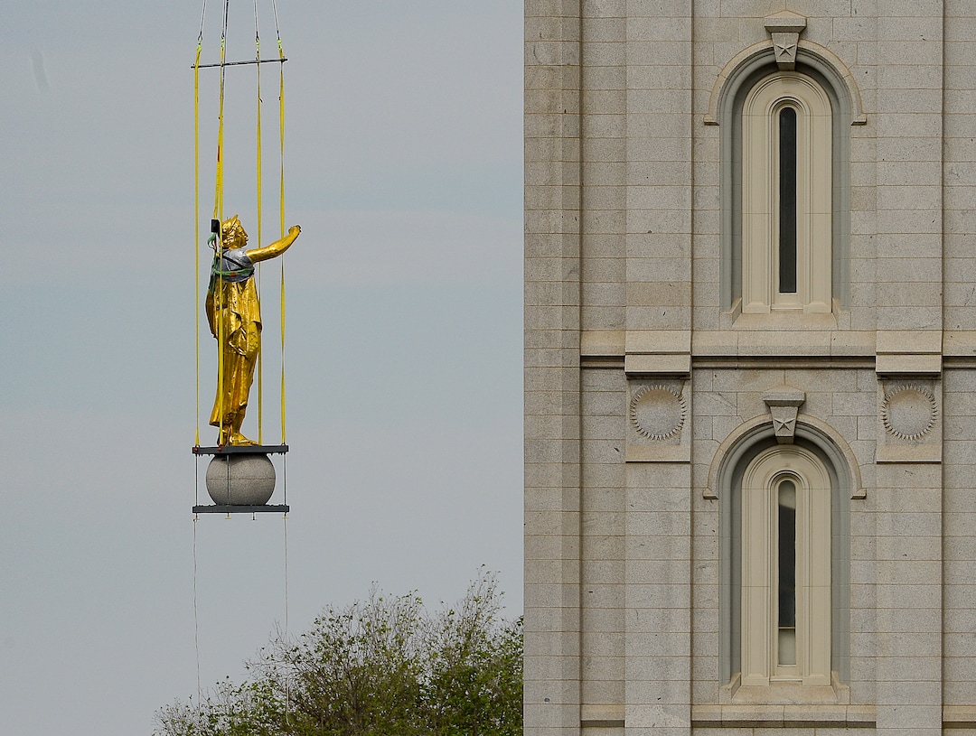 (Francisco Kjolseth  |  The Salt Lake Tribune) Crews work to remove the Angel Moroni statue atop the Salt Lake Temple of The Church of Jesus Christ of Latter-day Saints on Monday, May 18, 2020. The temple closed in December for seismic upgrades and sustained minor damager during the March 18, 2020, magnitude 5.7 earthquake when the trumpet held by the angel fell off and several smaller spire stones were displaced.