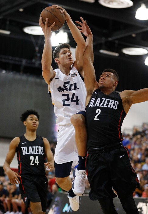 Utah Jazz's Grayson Allen (24) drives into Portland Trail Blazers' Wade Baldwin IV during the second half of an NBA summer league basketball game Saturday, July 7, 2018, in Las Vegas. (AP Photo/John Locher)