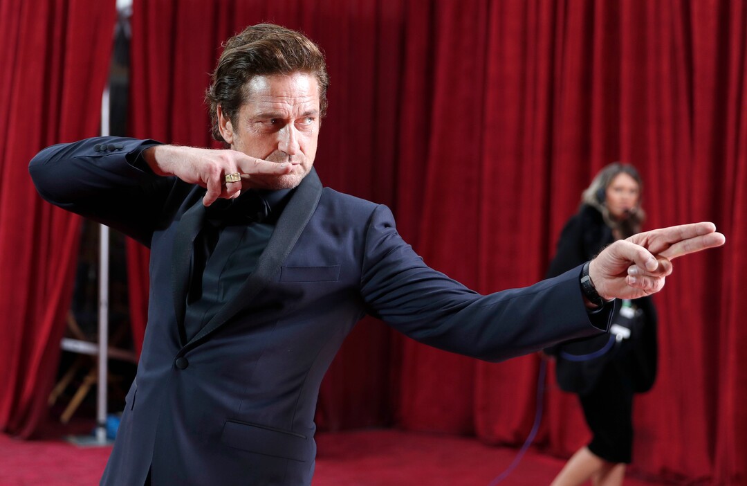 (John Locher | AP)  Gerard Butler poses as he arrives at the Oscars on Sunday, Feb. 9, 2020, at the Dolby Theatre in Los Angeles.