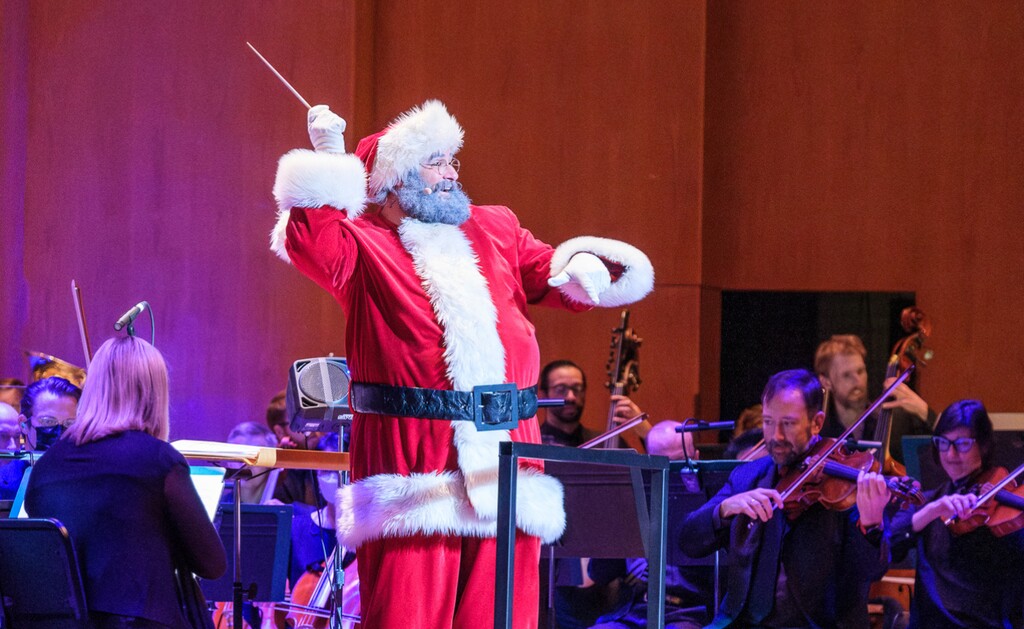 (Utah Symphony) Santa Claus (Lucas Proctor) conducts the Utah Symphony during "Here Comes Santa Claus!," the symphony's annual family concert for the holidays.