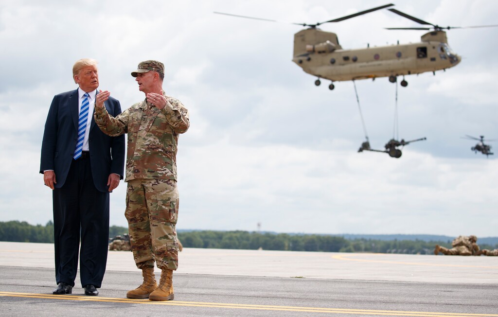 (AP Photo | Carolyn Kaster) President Donald Trump and Maj. Gen. Walter Piatt view air assault exercise at Fort Drum, N.Y., Monday, Aug. 13, 2018, before a signing ceremony for a $716 billion defense policy bill named for Sen. John McCain.