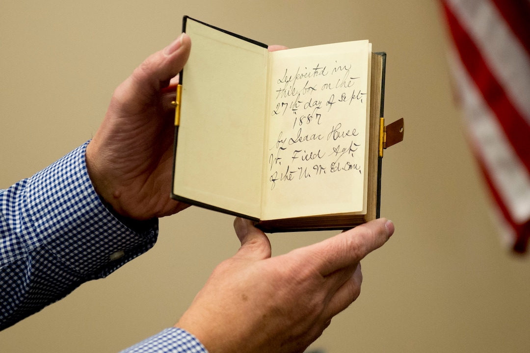 (Jeremy Harmon  |  The Salt Lake Tribune) Archivist Alan Barnett shows an inscription inside a bible from a time capsule that was buried in the corner stone of Ogden Academy on September 27, 1887. Items from the time capsule were displayed at the Utah State Archives on Wednesday, Oct. 16, 2019.