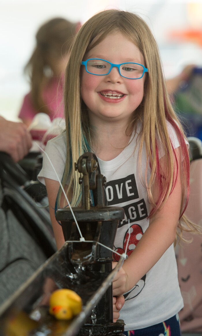 (Rick Egan  |  The Salt Lake Tribune)    Addison Devore, 7, form West Haven, sends a rubber duck down a slide by pumping a water pump, at the Davis County Fair in Farmington, Saturday, Aug. 18, 2018.