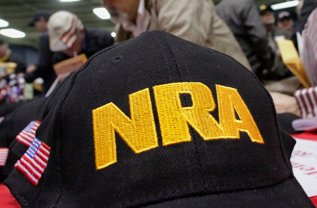 FILE- In this March 7, 2012, file photo, Illinois gun owners and supporters fill out National Rifle Association applications while participating in an Illinois Gun Owners Lobby Day convention before marching to the Illinois Capitol in Springfield, Ill. U.S. companies are taking a closer look at investments, co-branding deals and other ties to the gun industry and its public face, the National Rifle Association, after the latest school massacre. (AP Photo/Seth Perlman, File)