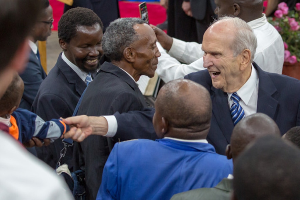 (Photo courtesy LDS Church) LDS Church President Russell M. Nelson wades into a crowd of Mormon well-wishers to shake hands Monday in Nairobi, Kenya.