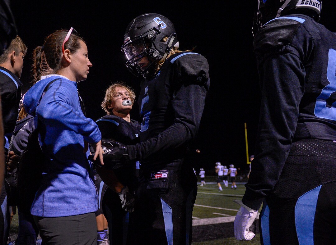 Leah Hogsten  |  The Salt Lake Tribune  West Jordan's Kalleb Klenk is checked for a concussion by team athletic trainer Sarah Bradley during  the game. West Jordan High School football team hosts Riverton High School, Thursday, Sept. 13, 2018 in West Jordan. 