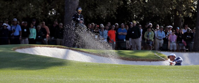 Tony Finau hits his second shot out of the fairway bunker on the first hole during the second round of the Masters golf tournament at Augusta National Golf Club in Augusta, Ga., Friday, April 6, 2018. (Bob Andres/Atlanta Journal-Constitution via AP)