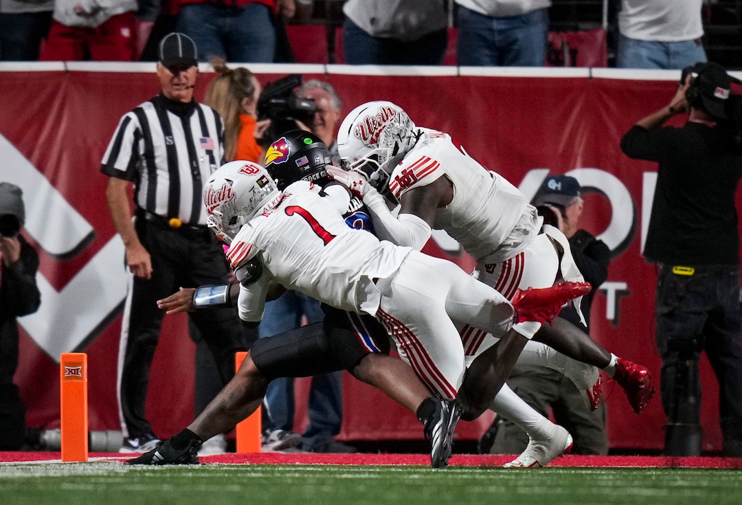 (Bethany Baker  |  The Salt Lake Tribune) Utah Utes safety Rabbit Evans (1) and Utah Utes linebacker Johnathan Hall (7) tackle Kansas Jayhawks quarterback Isaiah Marshall (8)  during the game between the Utah Utes and the Kansas Jayhawks at Rice-Eccles Stadium in Salt Lake City on Saturday, Oct. 10, 2026.