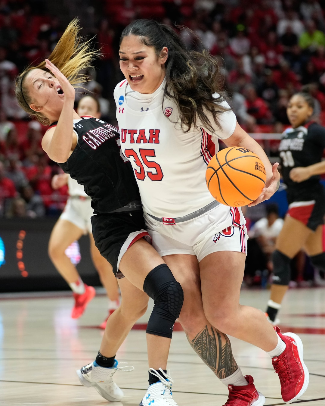 (Francisco Kjolseth | The Salt Lake Tribune) Utah Utes forward Alissa Pili (35) collides with Gardner-Webb Runnin' Bulldogs guard Lauren Bevis (2) as she dives the ball to the basket of a first-round college basketball game in the NCAA Tournament, Friday, March 17, 2023, in Salt Lake City, Utah.