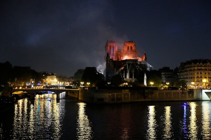 Notre Dame cathedral is seen burning in Paris, Monday, April 15, 2019. A catastrophic fire engulfed the upper reaches of Paris' soaring Notre Dame Cathedral as it was undergoing renovations Monday, threatening one of the greatest architectural treasures of the Western world as tourists and Parisians looked on aghast from the streets below. (AP Photo/Francois Mori)