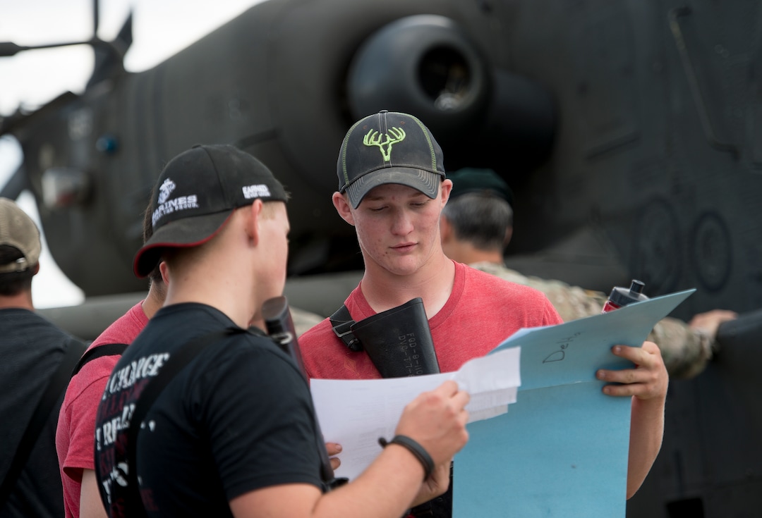 (Leah Hogsten  |  The Salt Lake Tribune) Porter Brown, 17, of Richfield and other attendees learn about a AH-64 Apache Attack helicopter from the 211th Aviation Group during the Utah National Guard Special Forces Survival Training Experience, August 10-12 at Camp Williams.