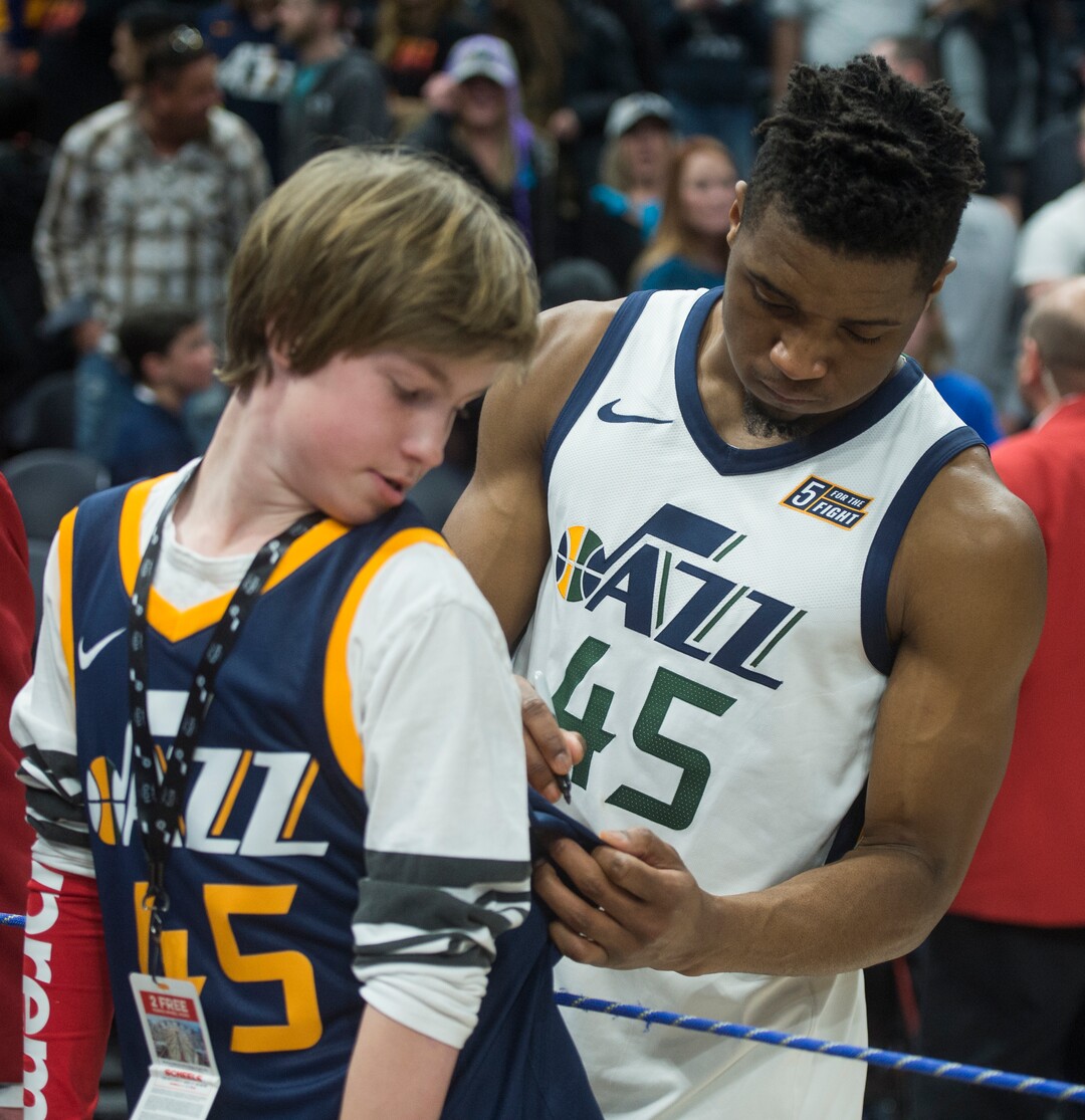 (Rick Egan  |  The Salt Lake Tribune)    Utah Jazz guard Donovan Mitchell (45) signs a jersey for Theron Bergeron, after the Jazz defeated the Dallas Mavericks in Salt Lake City, Saturday, Feb. 24, 2018.