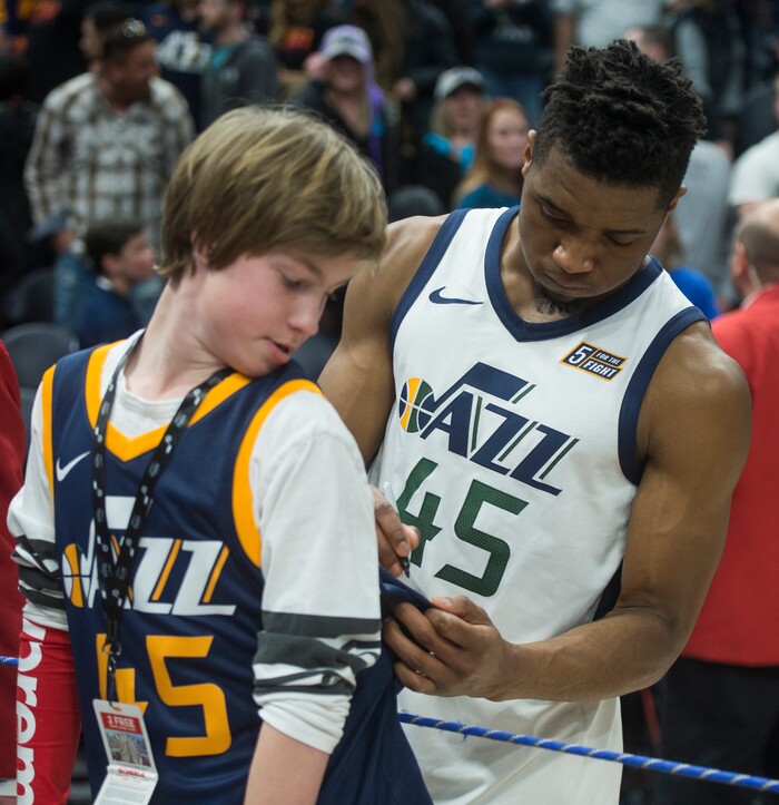 (Rick Egan  |  The Salt Lake Tribune)    Utah Jazz guard Donovan Mitchell (45) signs a jersey for Theron Bergeron, after the Jazz defeated the Dallas Mavericks in Salt Lake City, Saturday, Feb. 24, 2018.