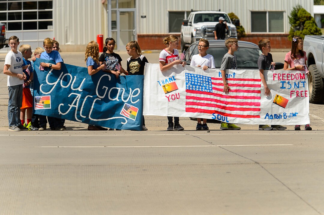 (Trent Nelson | The Salt Lake Tribune)  Crowds line Main Street in Monticello to honor the motorcade of fallen soldier Aaron Butler, who was killed last week in Afghanistan, , Thursday August 24, 2017.