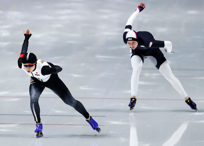 Silver medallist Miho Takagi of Japan, left, competes against Heather Bergsma, right, of the U.S. during the women's 1,500 meters speedskating race at the Gangneung Oval at the 2018 Winter Olympics in Gangneung, South Korea, Monday, Feb. 12, 2018. (AP Photo/John Locher)