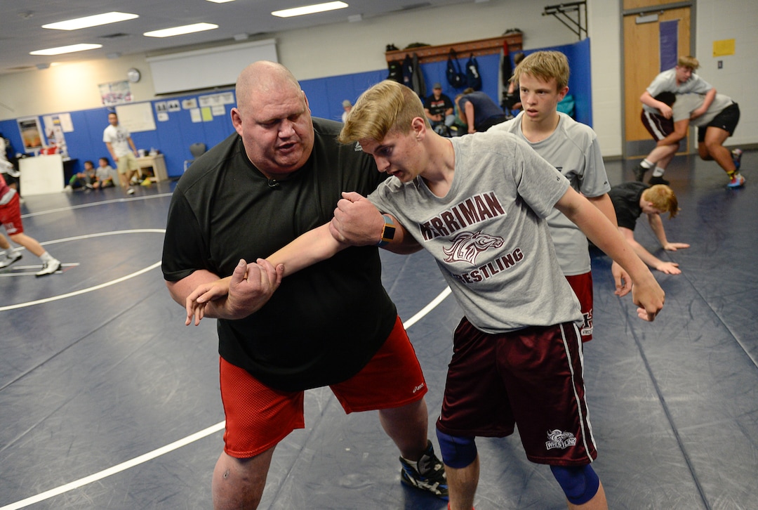 (Francisco Kjolseth  |  The Salt Lake Tribune)  Olympic wrestling champion Rulon Gardner runs an introductory clinic with Trey Holliday, 15, and other young wrestlers at Herriman High School after being introduced as the new coach on Wed. May 17, 2018.