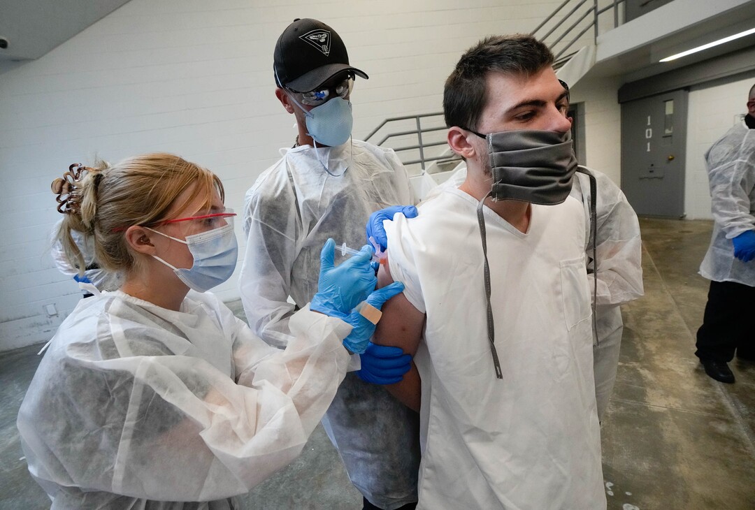(Francisco Kjolseth | The Salt Lake Tribune) Austin Stockard is administered the Johnson and Johnson COVID-19 vaccine by EMT Amanda Young during a vaccination event at the Utah State Prison in Draper on Tuesday, July 27, 2021. Stockard responded that he wanted to get the vaccine so he could meet with family during visiting hours.