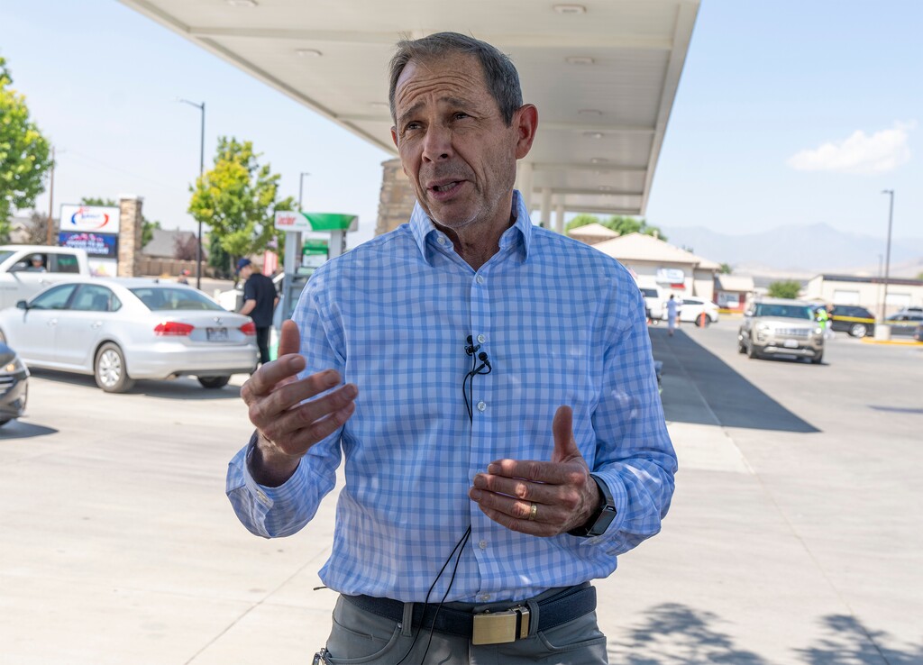 (Rick Egan | The Salt Lake Tribune)  Rep. John Curtis talks to the media as motorists line up to fill their tanks with unleaded gas at the price it was this time last year, in Lehi, on Tuesday, July 26, 2022.