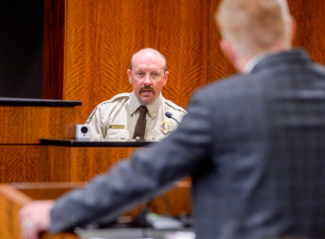 (Leah Hogsten  |  The Salt Lake Tribune) l-r Prosecution witness Ryan Riddle, the Iron County Fire Warden is questioned by Iron County prosecuting attorney, Chad Dotson. Robert Lyman, the man accused of starting the 2017 Brian Head Fire, was bound over for trial and pleaded not guilty to charges of reckless burning and burning during a closed fire season before Judge James Brady in Fourth District Court in Provo, Utah, July 30, 2019.