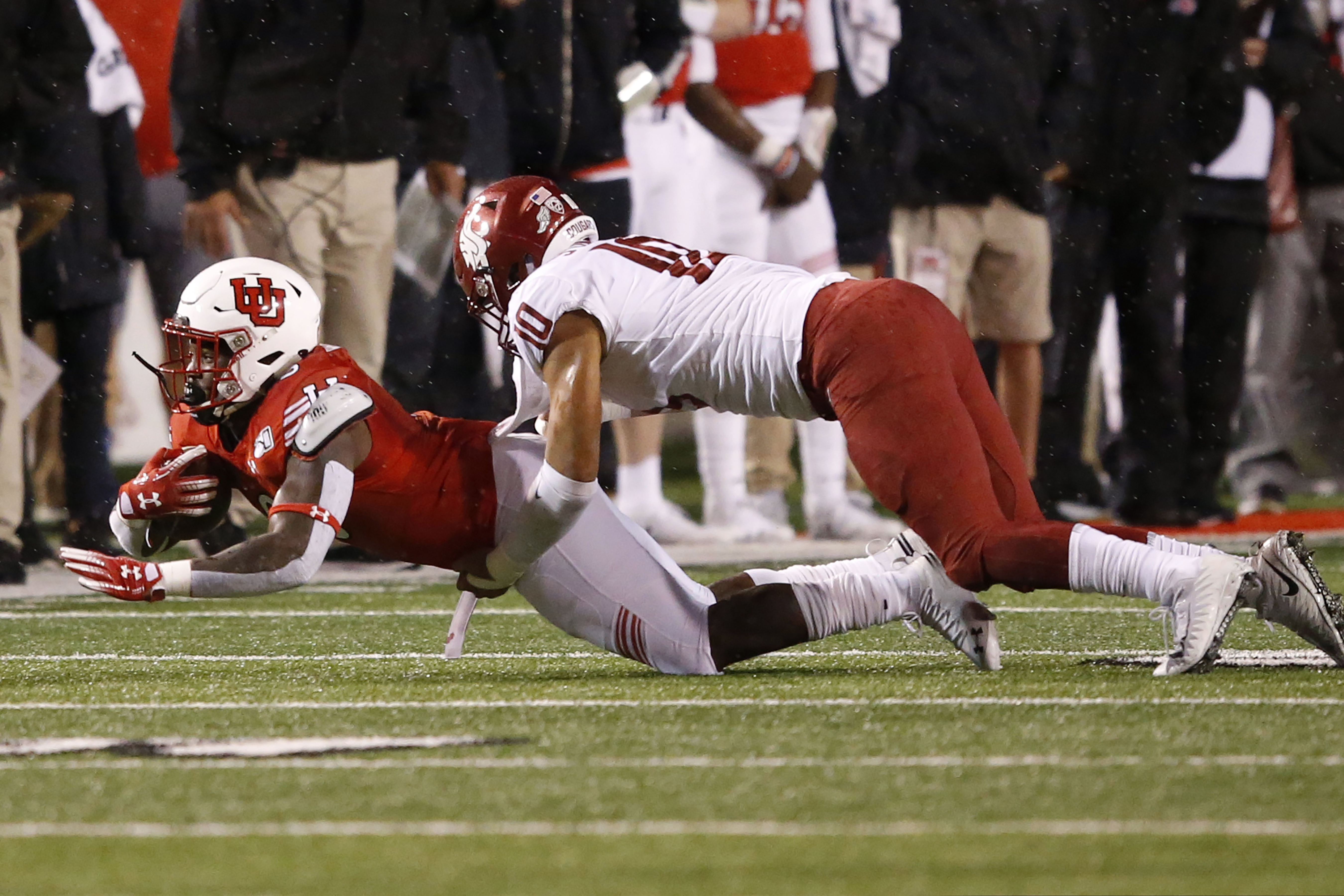 Washington State linebacker Ron Stone Jr. (10) tackles Utah running back Devin Brumfield, left, in the first half of an NCAA college football game Saturday, Sept. 28, 2019, in Salt Lake City. (AP Photo/Rick Bowmer)