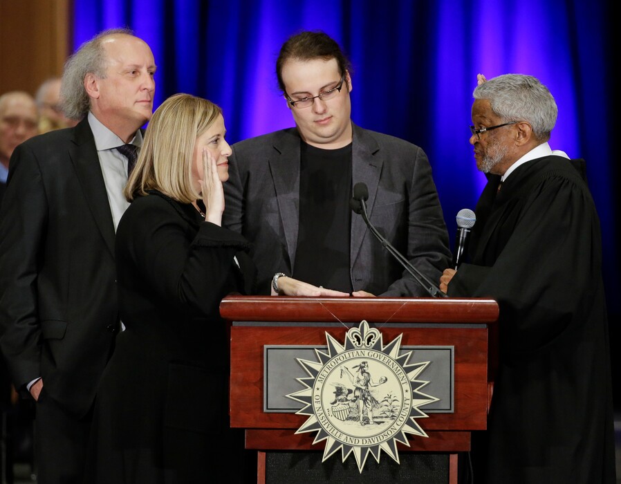 In this Friday, Sept. 25, 2015, file photo, Nashville Mayor Megan Barry, second from left, is sworn into office by Judge Richard Dinkins, right, with her husband, Bruce, left, and son, Max, second from right, in Nashville, Tenn.  (AP Photo/Mark Humphrey, File)