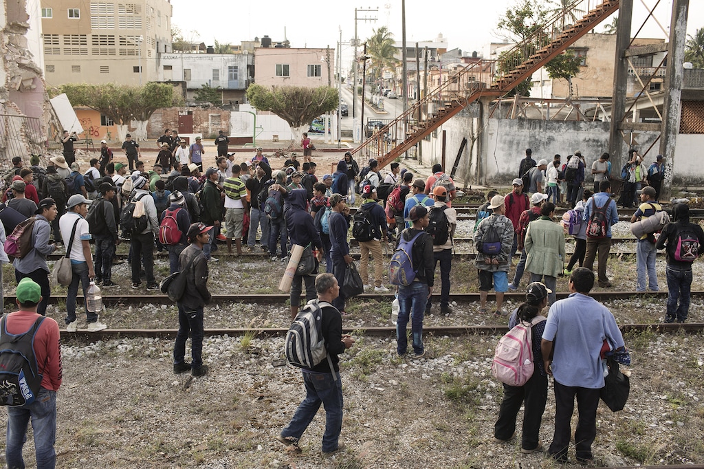 (Jordi Ruiz Cirera | Bloomberg) A group of Central American refugees and asylum seekers, led by the non-profit humanitarian organization Pueblos Sin Fronteras, a migrants rights group, wait to board "The Beast" freight train in Matias Romero, Mexico, on Sunday. It has been decided that the organized caravan will finish in Mexico City after a stop in the city of Puebla later this week.