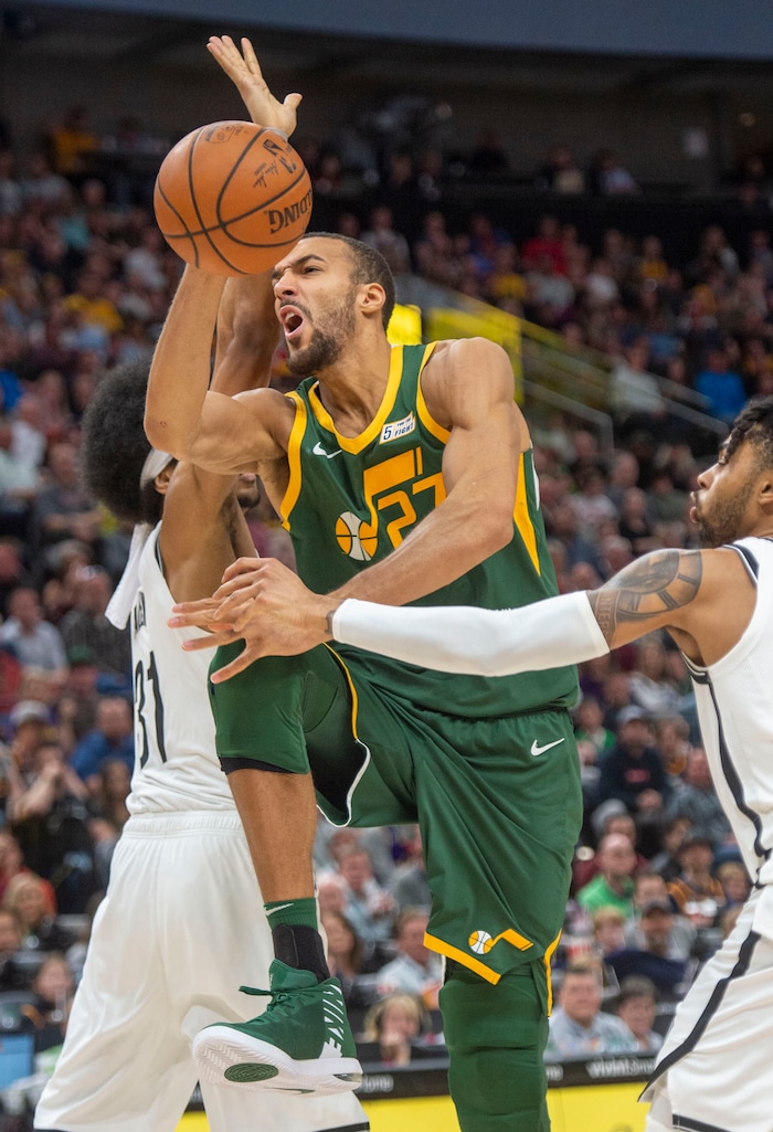 (Rick Egan  |  The Salt Lake Tribune)   Utah Jazz center Rudy Gobert (27) tries to go between Brooklyn Nets center Jarrett Allen (31) and guard D'Angelo Russell (1), in NBA action between Utah Jazz and Brooklyn Nets at Vivint Smart Home Arena, Saturday, March 16, 2019.


