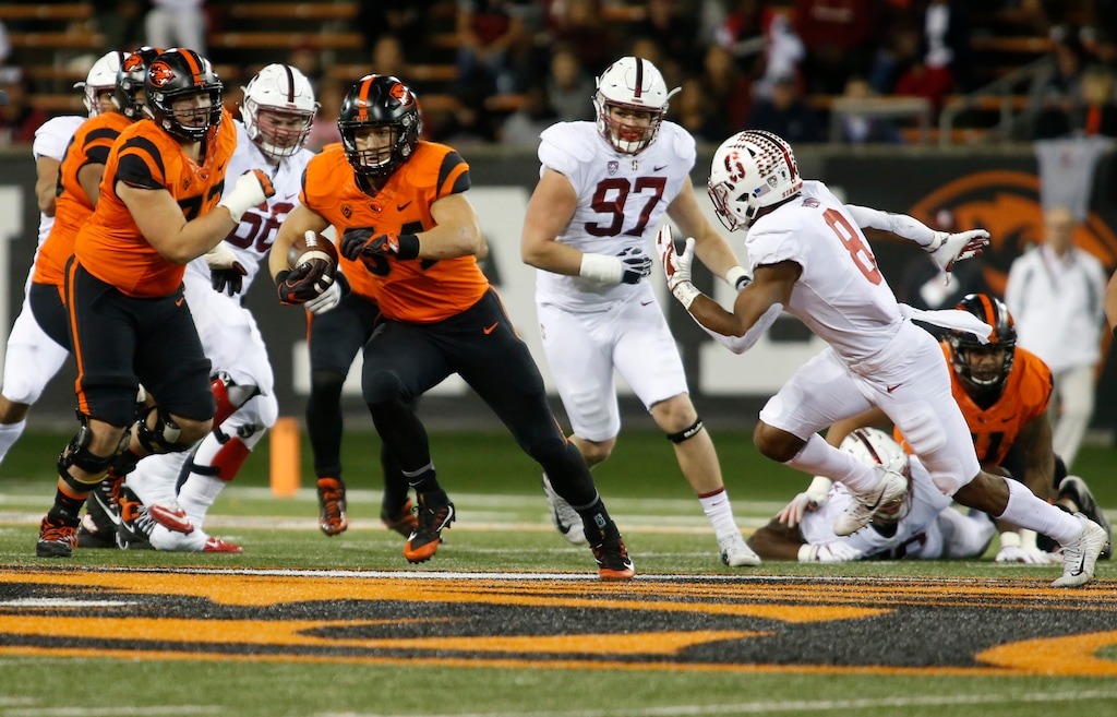 Oregon State running back Ryan Nall (34) tries to get past Stanford's Justin Reid (8) during the first half of an NCAA college football game, in Corvallis, Ore., Thursday, Oct. 26, 2017. (AP Photo/Timothy J. Gonzalez)