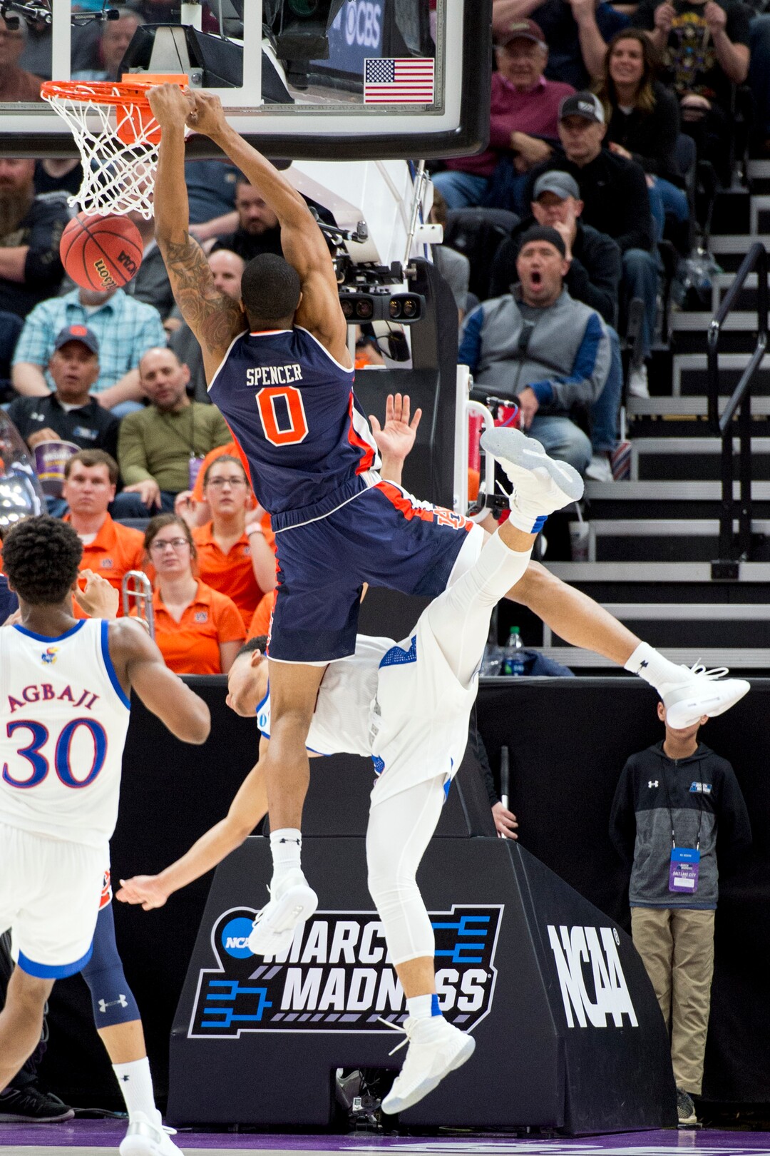 (Leah Hogsten  | The Salt Lake Tribune)  Auburn Tigers forward Horace Spencer (0) knocks over Kansas Jayhawks guard Devon Dotson (11) as Auburn faces Kansas in the second round of the NCAA tournament in Salt Lake City on Saturday, March 23, 2019.