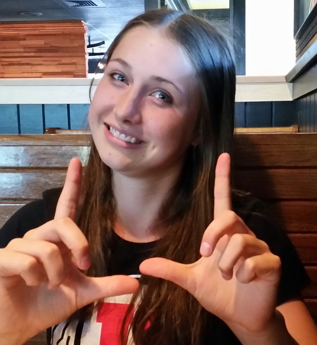 (Photo courtesy of Jill McCluskey) In this undated photo, Lauren McCluskey makes the "U" with her hands.