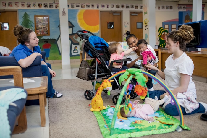 From left: inmates Destiny Doud, LaTonya Jackson and Christine Duckwitz play with their daughters April 9 at Decatur Correctional Center in Illinois. (Whitney Curtis | The Washington Post)