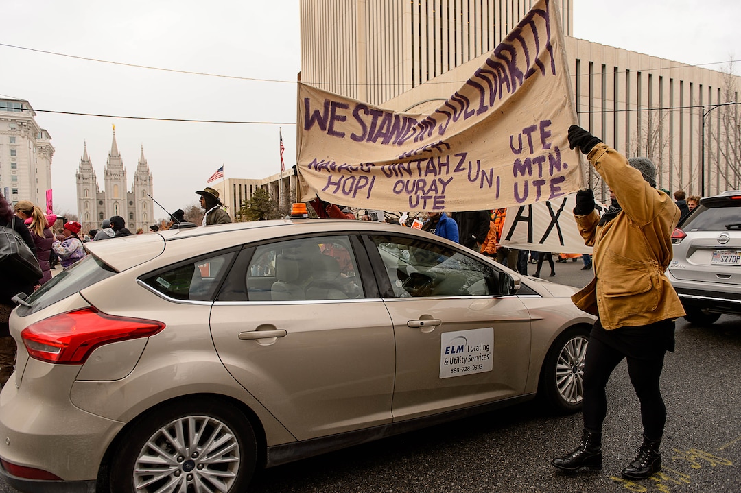 (Trent Nelson | The Salt Lake Tribune)  Protesters march down State Street through traffic after a rally against a visit by President Donald Trump, Monday December 4, 2017.