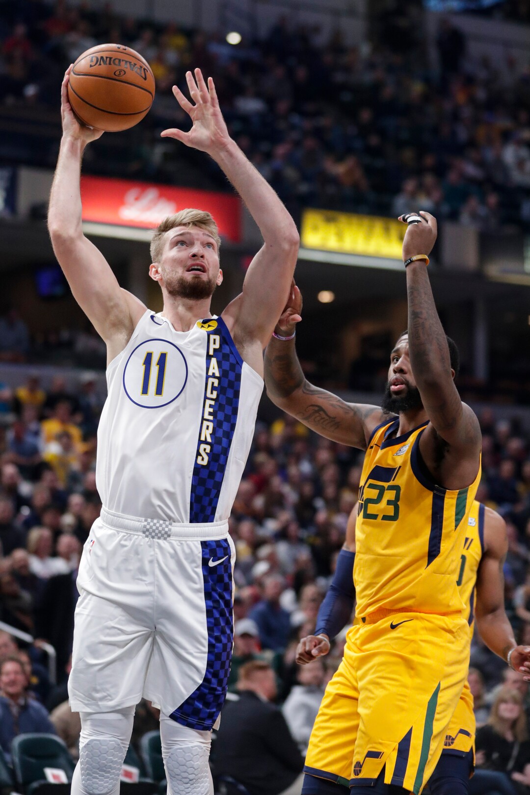 Indiana Pacers forward Domantas Sabonis (11) shoots in front of Utah Jazz forward Royce O'Neale (23) during the first half of an NBA basketball game in Indianapolis, Wednesday, Nov. 27, 2019. (AP Photo/Michael Conroy)