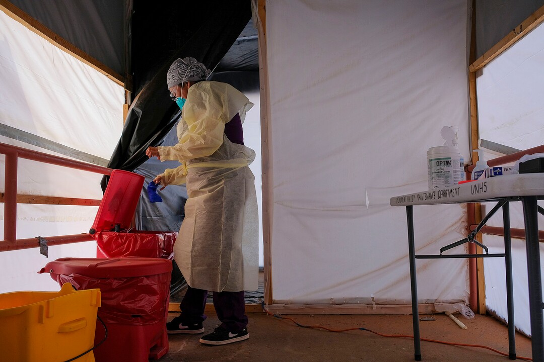 (Leah Hogsten  |  The Salt Lake Tribune) Shelly Begay, a Diné medical assistants at Utah Navajo Health System’s Monument Valley Clinic, strips off her gloves and gown in the mobile triage unit’s decontamination area after  administering a coronavirus test to a patient. Aug., 24, 2020.
