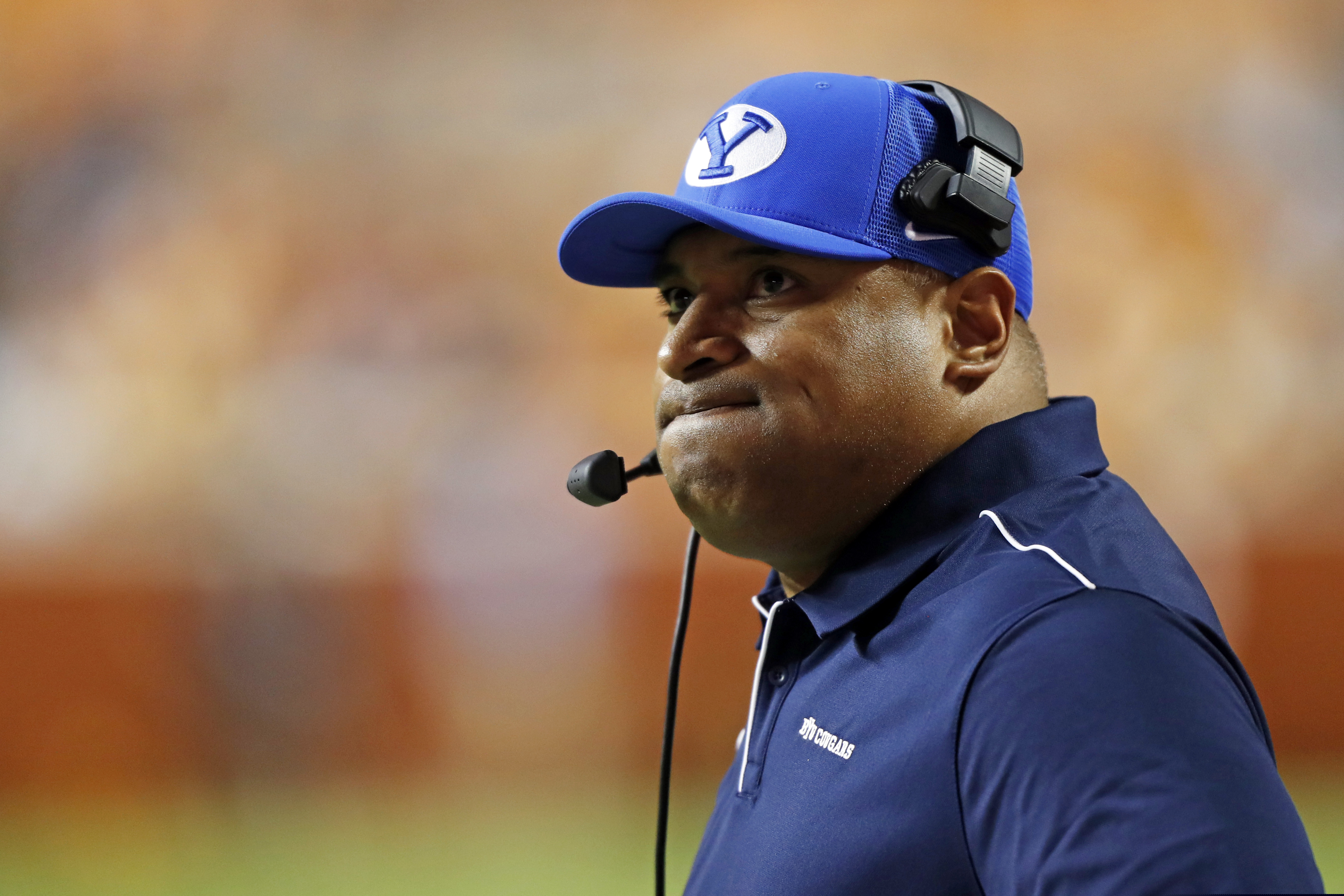 FILE - In this Sept. 7, 2019 file photo, Brigham Young head coach Kalani Sitake looks at a replay on the Jumbotron in the first half of an NCAA college football game against Tennessee in Knoxville, Tenn. For the first time since 1989, BYU and Navy will get together for a football game at the Naval Academy in Annapolis, Md., on Monday, Sept. 7, 2020.   (AP Photo/Wade Payne, File)