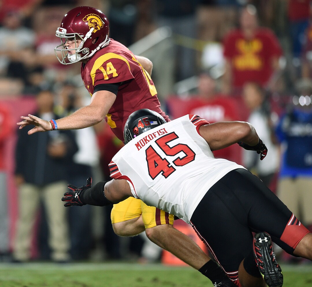Southern California quarterback Sam Darnold, back, runs to avoid the tackle by Utah defensive tackle Filipo Mokofisi during the second half of an NCAA college football game in Los Angeles, Saturday, Oct. 14, 2017. USC won 28-27. (AP Photo/Kelvin Kuo)