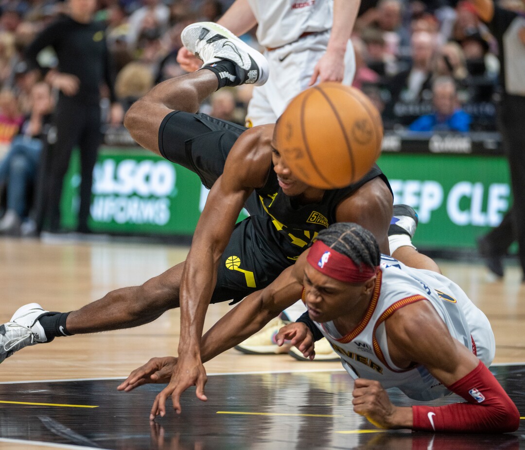 (Rick Egan | The Salt Lake Tribune) Utah Jazz guard Kris Dunn (11) and Denver Nuggets forward Peyton Watson (8) collide in NBA action between the Utah Jazz and the Denver Nuggets at Vivint Arena,  Saturday, April 8, 2023.