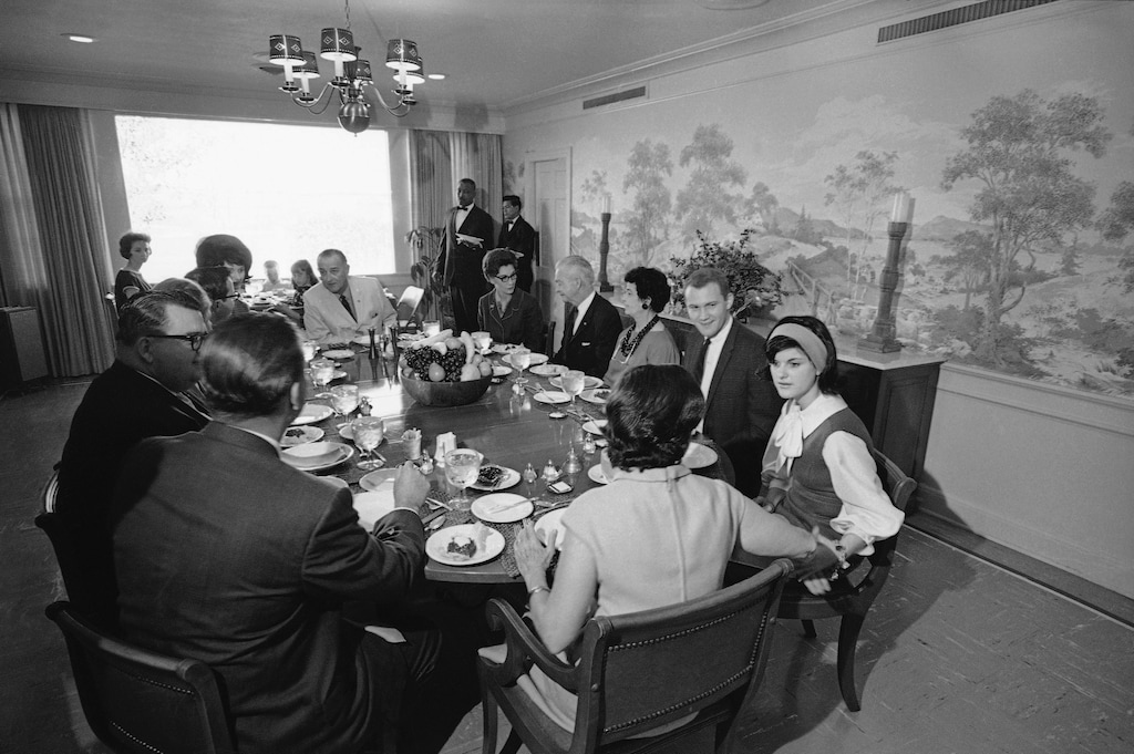 President Lyndon Johnson is seated at head of table, as family and friends gather for Thanksgiving Day dinner at the LBJ Ranch in Stonewall, Texas, Nov. 25, 1965. (AP Photo/Charles Tasnadi)