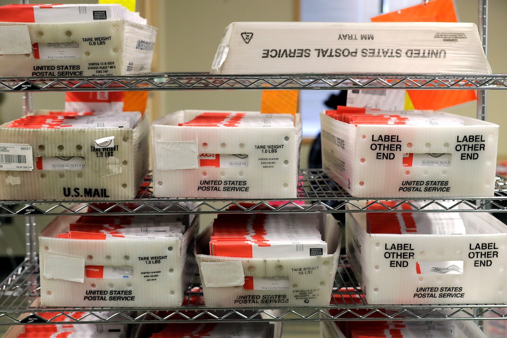 (Ted S. Warren | AP file photo) - In this Aug. 5, 2020, file photo vote-by-mail ballots are shown in U.S. Postal service sorting trays the King County Elections headquarters in Renton, Wash., south of Seattle. The Democratic-run House on Sunday demanded that leaders of the U.S. Postal Service testify at an emergency oversight hearing Aug. 24 on mail delays.