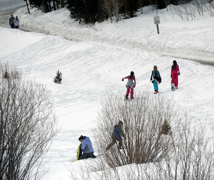(Al Hartmann  |  The Salt Lake Tribune) 	
People snowshoe along Cardiff Road in Big Cottonwood Canyon Monday March 12.