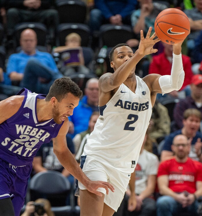 (Rick Egan  |  The Salt Lake Tribune)      Utah State Aggies forward Dwayne Brown Jr. (2) passes the ball down court, as Weber State Wildcats forward Brekkott Chapman (23)defends, in basketball acton in the Beehive Classic, between against the Utah State Aggies and Weber State Wildcats, a the Vivint Smart Home Arena, Saturday December 8, 2018.

 