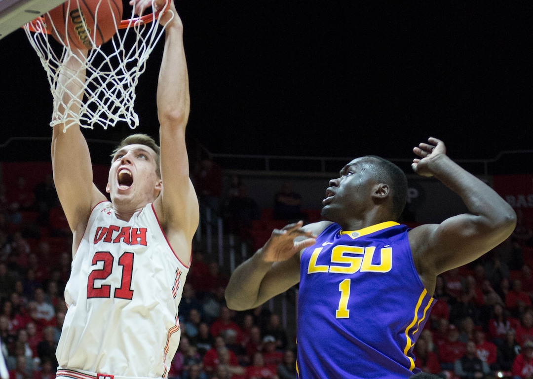 (Rick Egan  |  The Salt Lake Tribune)   Utah Utes forward Tyler Rawson (21) dukes the ball as LSU Tigers forward Duop Reath (1) defends , in NIT playoff action between Utah Utes and LSU Tigers at the Jon M. Huntsman Center, Monday, March 19, 2018.