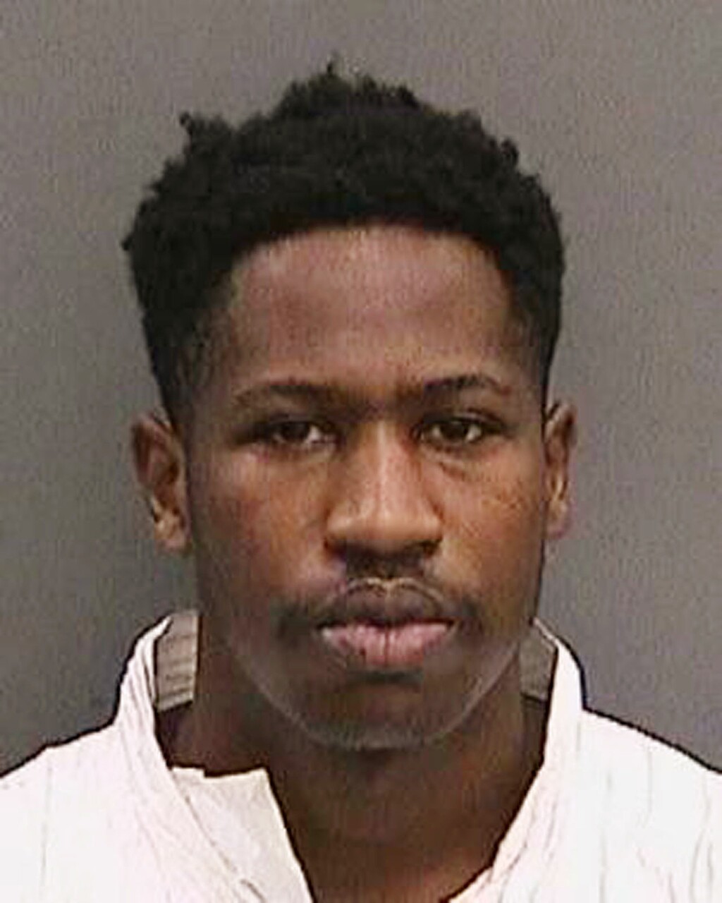 This booking photo provided by the Tampa Police Department, Fla., on Wednesday, Nov. 29, 2017, shows Howell Emanuel Donaldson. Donaldson, the suspect in a string of four slayings that terrorized a Tampa neighborhood was arrested after he brought a loaded gun to his job at a McDonald's and asked a co-worker to hold it, authorities said.  (Tampa Police Department via AP)