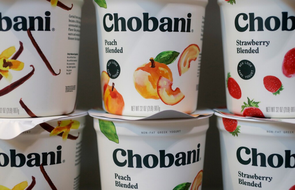 (Mark Lennihan | The Associated Press) In this Monday, Nov. 20, 2017 photo, Chobani yogurt cups are displayed in New York. Chobani, the company that helped kick-start the Greek yogurt craze, is shrinking those words from its label as it hints it may expand beyond that food in an increasingly crowded yogurt market.