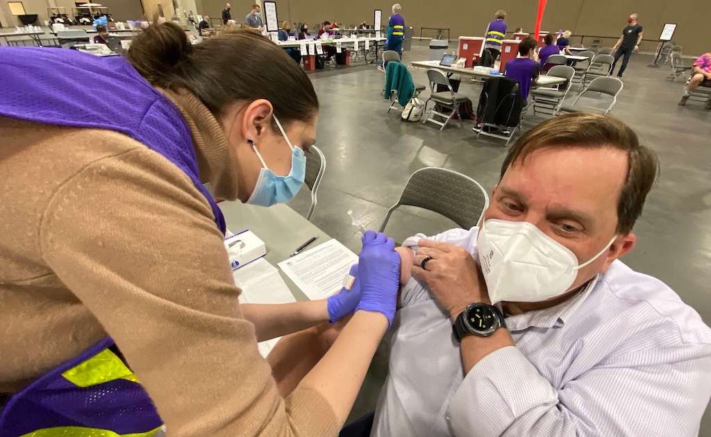(Rick Egan | The Salt Lake Tribune) Angela Bolt administers COVID -19 vaccine to Robert Morarty, at the Mountain America Expo site in Sandy on Monday, March 8, 2021.