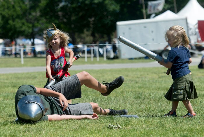 (Rick Egan  |  The Salt Lake Tribune)      Graeme 4, and Rhys Blysma, 3, from Midvale, fight a knight at the 44th annual Utah Scottish Festival and Highland Games at the Utah State Fairgrounds, Sunday, June 10, 2018.