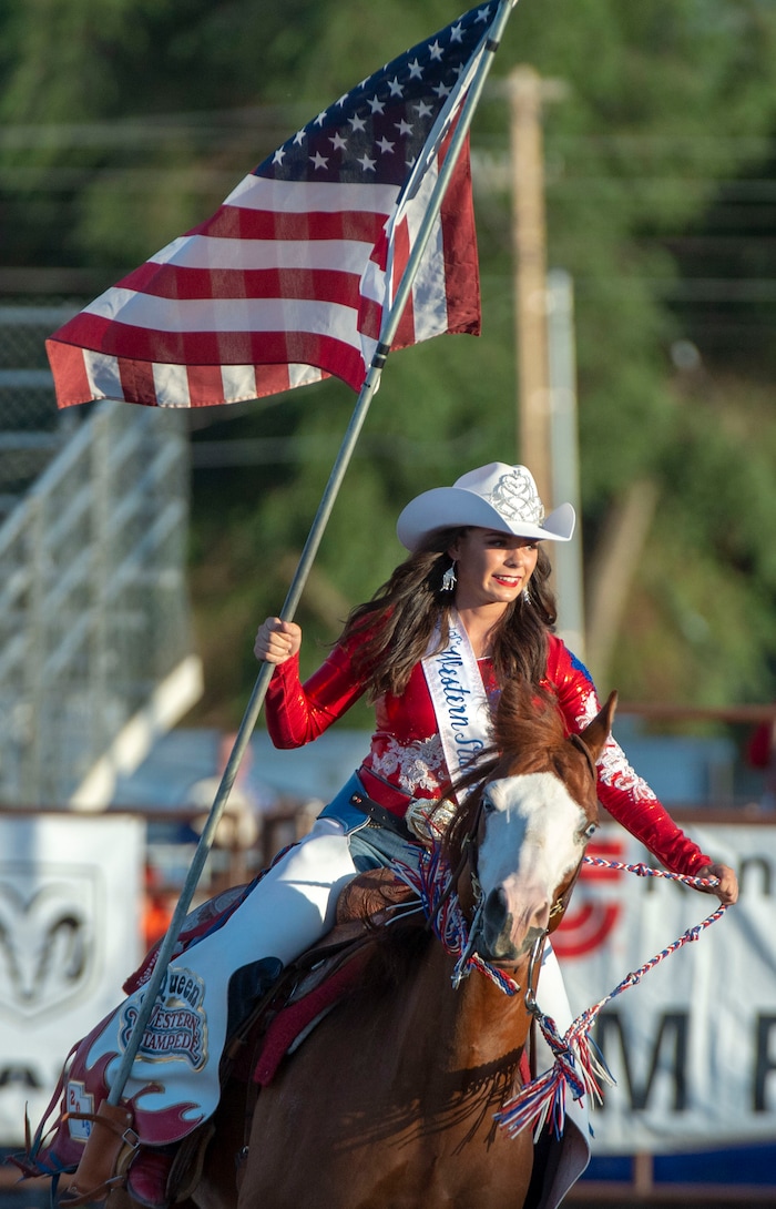 (Rick Egan  |  The Salt Lake Tribune)    Rodeo Queen Raegann McCurdy brings out the American Flag, at the West Jordan Western Stampede Rodeo, Saturday, July 6, 2019.