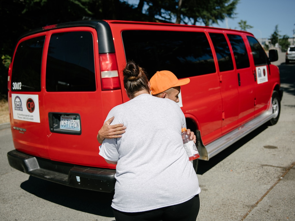 (Grant Hindsley for The New York Times) 

Nhan Dinh Truong hugs Ms. Alexander while loading a van before heading to a hotel room supplied by JustCare.